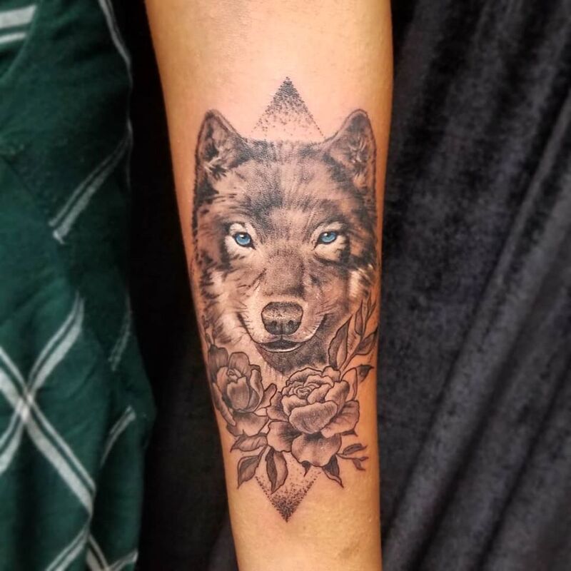 Wolf with flower tattoo done at Overlord Tattoo Shop in Palm Coast FL